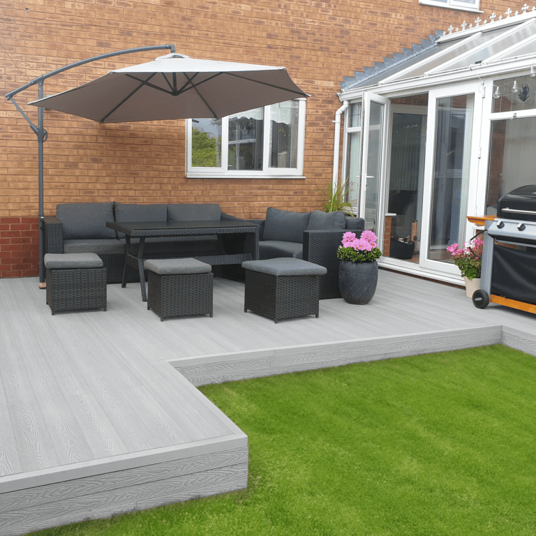 Outdoor patio featuring light grey composite decking, modern furniture, and a large umbrella for shade.