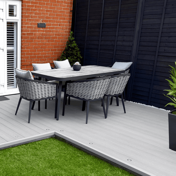 Stylish outdoor dining area featuring a 2.8m light grey composite decking board and modern wicker furniture.
