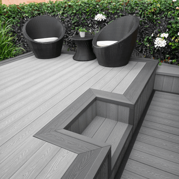 Elegant outdoor space featuring light grey composite decking, stylish chairs, and a modern design.