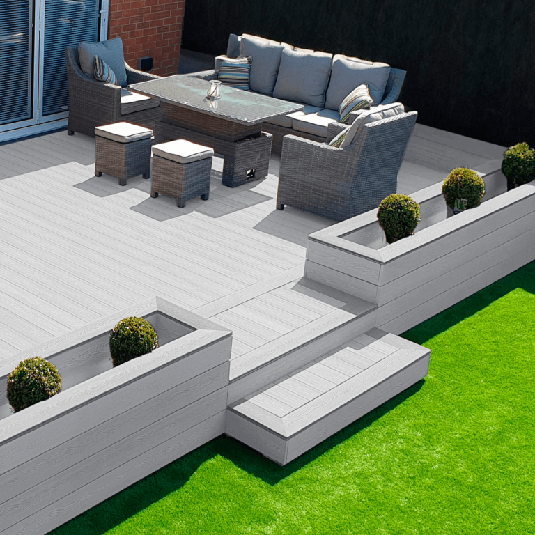 Premium light grey composite decking board enhancing an outdoor living space with modern furniture and greenery.
